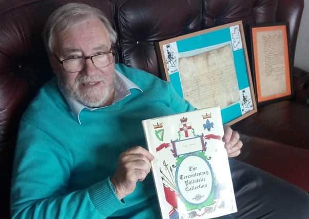 Robert McAuley with his Tercentenary Collection of first day covers which commemorates 14 of King Williams battles in Ireland. In the background are two signed letters from King William and the Duke of Leinster, Meinhardt Schomberg