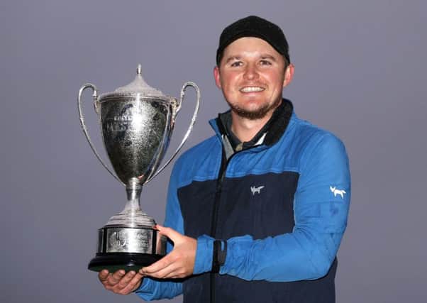 Eddie Pepperell celebrates with the trophy after winning the British Masters