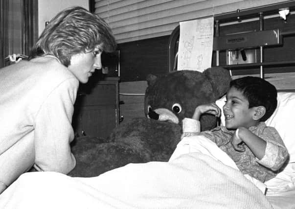 The Princess of Wales chats to Rajan Parmar, a young victim of the Harrods bomb in 1983