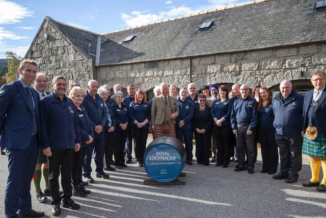 The Prince of Wales, known as the Duke of Rothesay while in Scotland, poses for a group photograph with the distillery staff during a visit to the Royal Lochnagar Distillery at Crathie on Royal Deeside.