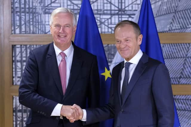 EU chief Brexit negotiator Michel Barnie, left, shakes hands for the media with European Council President Donald Tusk prior their talks at the European Council headquarters in Brussels, Tuesday, Oct. 16, 2018. Britain is set to leave the European Union in March, but a Brexit agreement must be sealed in coming weeks to leave enough time for relevant parliaments to ratify it. (Olivier Hoslet, Pool Photo via AP)