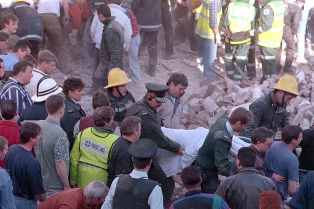 Emergency services removing a body from the rubble after the Shankill Bomb in 1993. Photo: Pacemaker