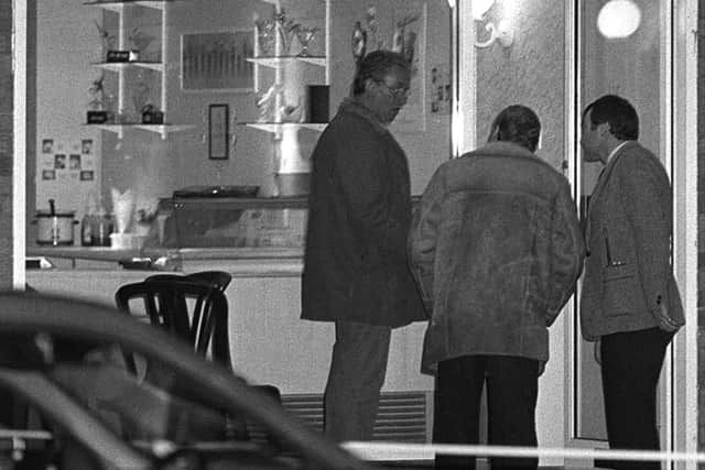 RUC detectives examine the scene of Constable John Larmours murder on Belfasts Lisburn Road on August 11, 1988