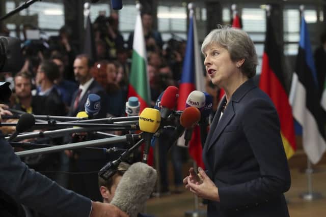UK prime Minister Theresa May speaks with the media as she arrives for an EU summit in Brussels, Wednesday, Oct. 17, 2018. (AP Photo/Francisco Seco)