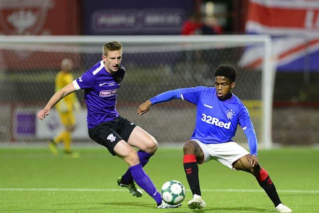 Larne's Jeff Hughes and Rangers XI Adedapo Awokoya-Mebude. Picture By: Arthur Allison: Pacemaker Press.