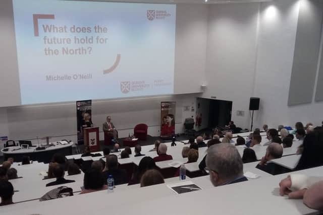 Michelle O'Neill, northern leader of Sinn Fein, speaking at Queen's University in Belfast on Wednesday as part of its Policy Engagement Lecture Series. Anne Graham, sister of the murdered lawyer Edgar, the back of whose head is towards the middle of the picture, asked a question from the audience