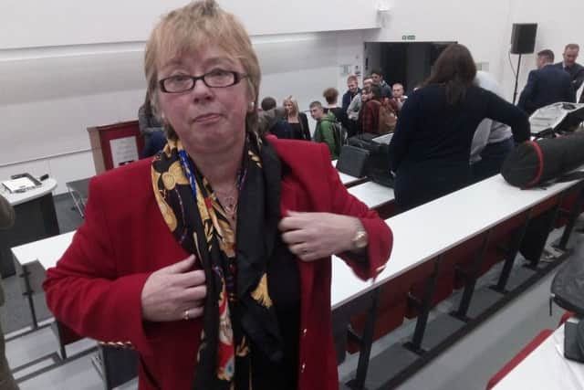Anne Graham prepares to leave the lecture theatre after  speaking to Michelle O'Neill
