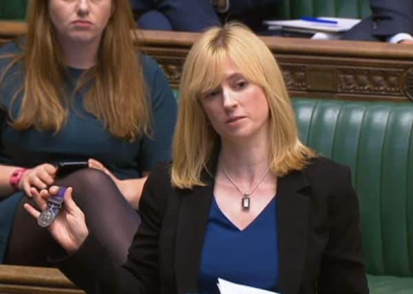 Labour MP for Canterbury, Rosie Duffield, holds up a medal from one of her constituents in the House of Common