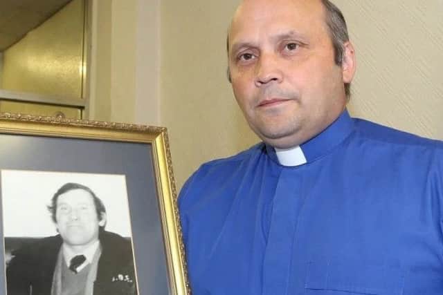 Rev Alan Irwin with a picture of his father Thomas, murdered by the IRA in 1986