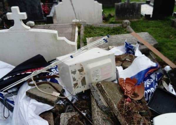 Items including a microwave and a clothes horse were dumped in the cemetery.