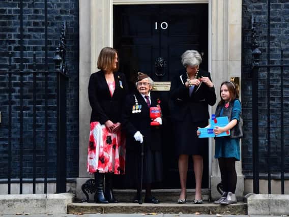 (left to right) Claire Rowcliffe, Royal British Legion Director of Fundraising, WWII veteran Barbara Weatherill, 93, Prime Minister Theresa May and fundraiser Poppy Railton, 9, outside 10 Downing Street, London as the Prime Minister makes a donation to the Royal British Legion's Poppy Appeal and receives her poppy.