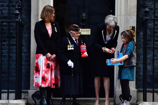 left to right) Claire Rowcliffe, Royal British Legion Director of Fundraising, WWII veteran Barbara Weatherill, 93, Prime Minister Theresa May and fundraiser Poppy Railton, 9, outside 10 Downing Street, London as the Prime Minister makes a donation to the Royal British Legion's Poppy Appeal and receives her poppy.