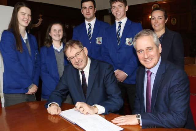 Ã‰amon O' CuÃ­v TD (left) signed the visitors' book at St Killian's College. Included are principal Jonny Brady, head of history Mrs. S Kinney and pupils. Pictures by Paddy McIlwaine.