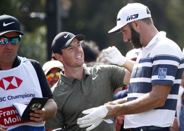 Rory McIlroy chats with Dustin Johnson