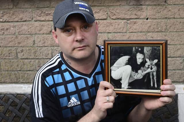 Gary Murray pictured holding a photo of his 13-year-old sister LeeAnn, who was killed in the Shankill bombing.
 Picture: Arthur Allison/Pacemaker Press