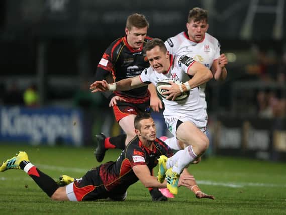 Dragons Jason Tovey makes a try saving tap tackle on Ulster's Michael Lowry
