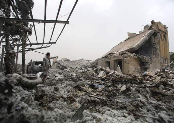 A man stands on the rubble of a house destroyed by a Saudi-led airstrike on the outskirts of Sanaa, Yemen, June 9, 2015 (AP Photo/Hani Mohammed)