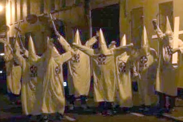 Reports that a group of people dressed as Ku Klux Klan (KKK) members posed outside an Islamic prayer house are being investigated as a hate incident, police said.