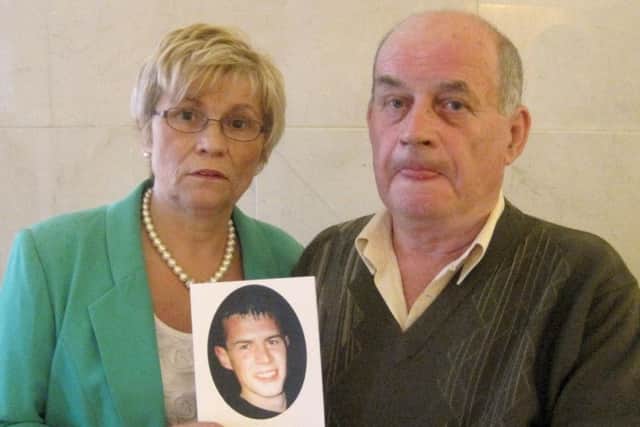 Briege Quinn and her husband Stephen with a photo of their son Paul, who was murdered by the IRA in Co Monaghan in 2007