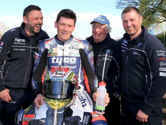 Dan Kneen with the Tyco BMW team at the Tandragee 100 in May, where he won the feature race.