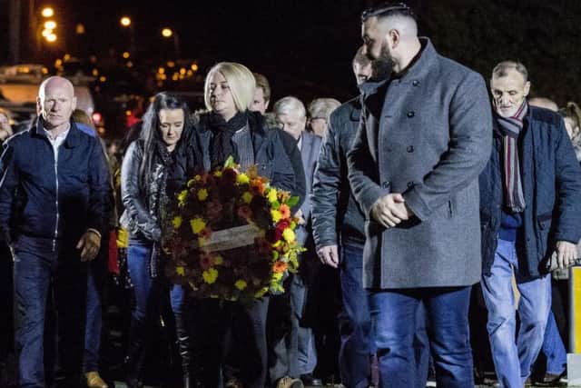 Daughter of John Burns, Gillian holding a wreath, as other members of the Greysteel massacre families look on during a vigil to commemorate the 25th anniversary of eight people being murdered on 30 October 1993 by members of the UFF. Photo: Liam McBurney/PA Wire