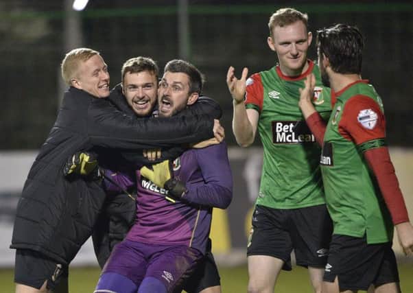 Glentoran players celebrate with Elliott Morris after a late penalty shootout at The Oval.