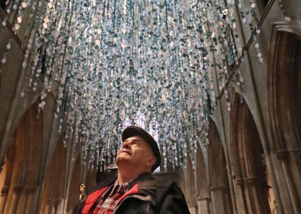 Vlad Mountaniol from Los Angeles watches as the 36,000 leaf-shaped messages are hung from St Patrick's Cathedral ceiling in Dublin