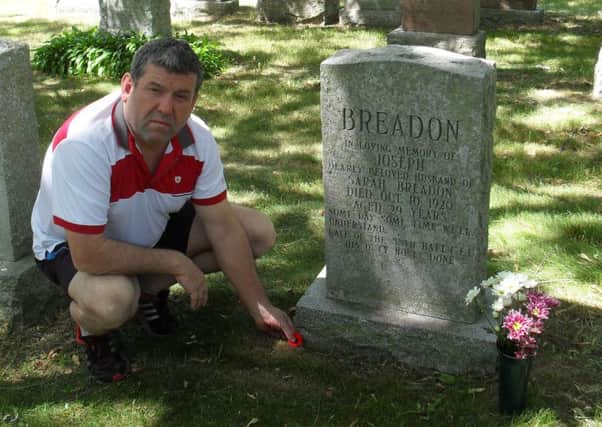 Iain Lendrum at the grave of Pte Joseph Breadon.
