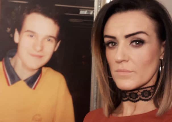 Claire Monteith pictured alongside a photograph of her brother, Alan Radford, who died in the Omagh bombing