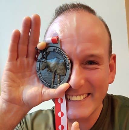 Gary Bell with his Arctic Marathon medal
