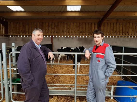 Hugh Smyth, right and his son Kyle pictured with some of the calves which have been tagged with Caisley tags