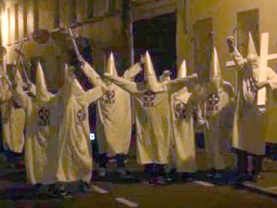 Group dressed as Ku Klux Klan members