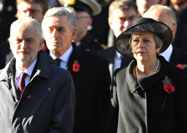 Labour leader Jeremy Corbyn and Prime Minister Theresa May during the remembrance service at the Cenotaph memorial in Whitehall, central London, on the 100th anniversary of the signing of the Armistice