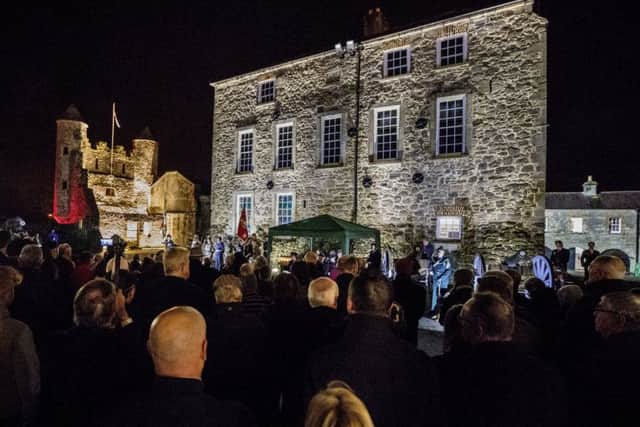 People attend a dawn Armistice Day ceremony at Enniskillen Castle in Co Fermanagh, Northern Ireland, on the 100th anniversary of the signing of the Armistice which marked the end of the First World War.