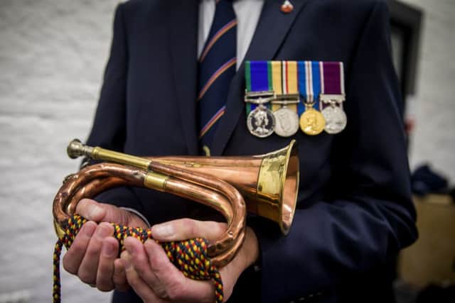 Bugler Noel Trimble holds the bugle that sounded the charge of the 36th Ulster Division at the Battle of the Somme, ahead of a dawn Armistice Day ceremony at Enniskillen Castle