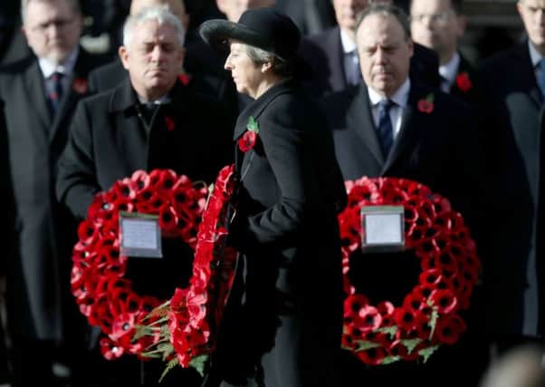 Prime Minister Theresa May lays a wreath during the remembrance service at the Cenotaph memorial in Whitehall, central London, on the 100th anniversary of the signing of the Armistice which marked the end of the First World War. PRESS ASSOCIATION Photo. Picture date: Sunday November 11, 2018. See PA story MEMORIAL Armistice.