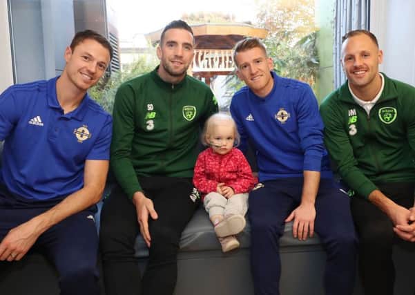Players from the Northern Ireland and Republic of Ireland football squads came together today to visit Irelands largest paediatric hospital, Our Ladys Childrens Hospital in Dublin, to support children with cancer and to highlight the work of medical and caring staff who help to fight the disease.
Northern Ireland's Steven Davis and Jonny Evans with Republic of Ireland's Shane Duffy and David Meyler visited 2 year old Ellen Meehan at Irelands largest paediatric hospital, Our Ladys ChildrensÂ HospitalÂ Crumlin, to encourage young people who have cancer and to highlight the work of medical and caring staff who help to fight the disease.