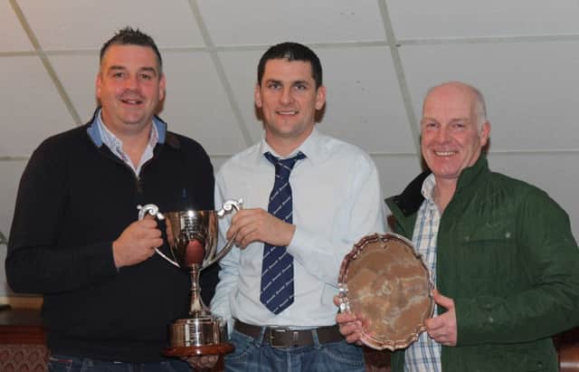 Spring show and sale prize winners Keith Nelson, Rosslea, and Norman Robson, Doagh, received their awards from NI Simmental Cattle Breeders' Club chairman Conard Fegan. Picture: Julie Hazelton