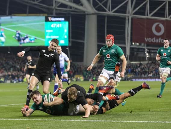 Jacob Stockdale crosses for a try for Ireland against New Zealand