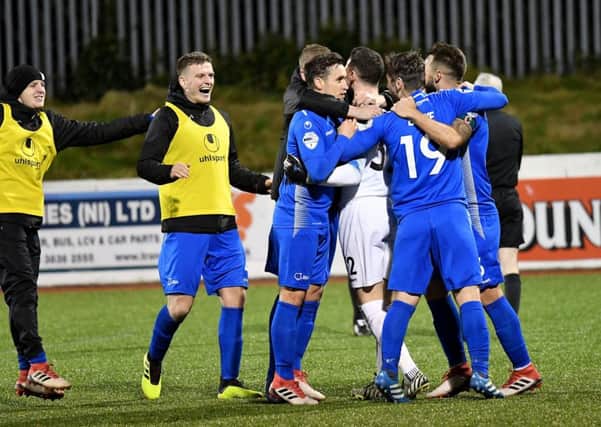 Dungannon players celebrate after winning on penalties against Cliftonville
