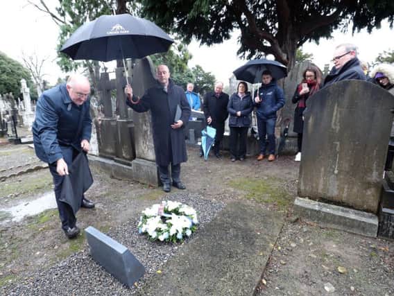 A monument to 14-year-old John William Scott, who was shot and killed on Bloody Sunday at Croke Park in 1920 when British forces opened fire during a GAA match, is unveiled by GAA president John Horan (left) in Dublin's Glasnevin cemetery.