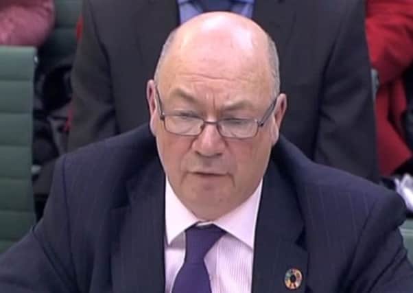 Foreign Office minister Alistair Burt being quizzed by MPs on the Northern Ireland Affairs Committee about compensation from Libya for IRA victims.