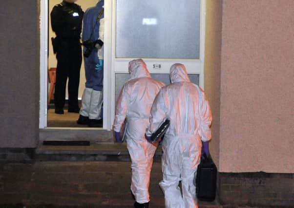 Police and forensic investigators in the Devenagh Court area of Ballymena where the man was found dead