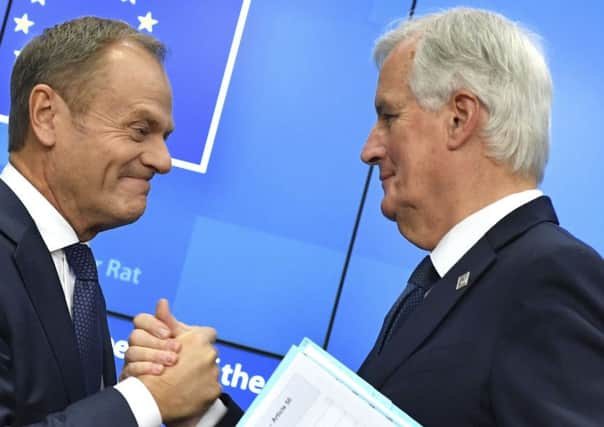 European Council President Donald Tusk, left, shakes hands with European Union chief Brexit negotiator Michel Barnier during a media conference. (AP Photo/Geert Vanden Wijngaert)