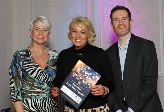 Tracy Collins from Cookstown received the Community Group SuperStar award, on behalf of Team Aspie, at a glittering awards ceremony at Titanic Hotel, which recognised over 30 inspirational individuals from across Northern Ireland. Pictured (L-R): Host Pamela Ballantine; Tracy Collins, Community Group SuperStar winner; and Brendan Gallen, Head of Marketing, Musgrave.