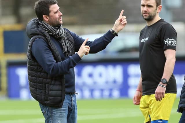 William Dunlop with David Healy, manager of the Road Racers team, at the annual bike racers' charity football match at Seaview in January.