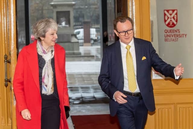 Theresa May arrives at Queen's University in Belfast yesterday where she is greeted by the vice chancellor, Ian Greer. The prime minister met business and voluntary leaders and later talked to politicians at Stormont
