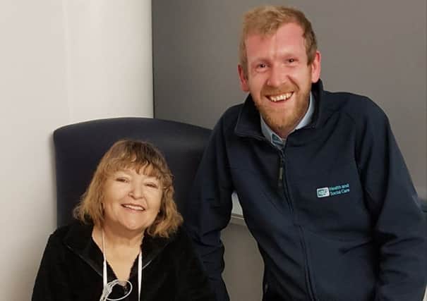 Christine McNeice with Simon Price - one of the three people who saved her life when she took a heart attack in the car park at the Royal Victoria Hospital on November 21.