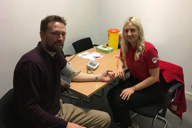 News Letter reporter Duncan Elder gets his blood pressure checked by Amy Coey, NICHS health promotion officer.