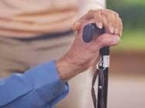 An elderly man with a cane
